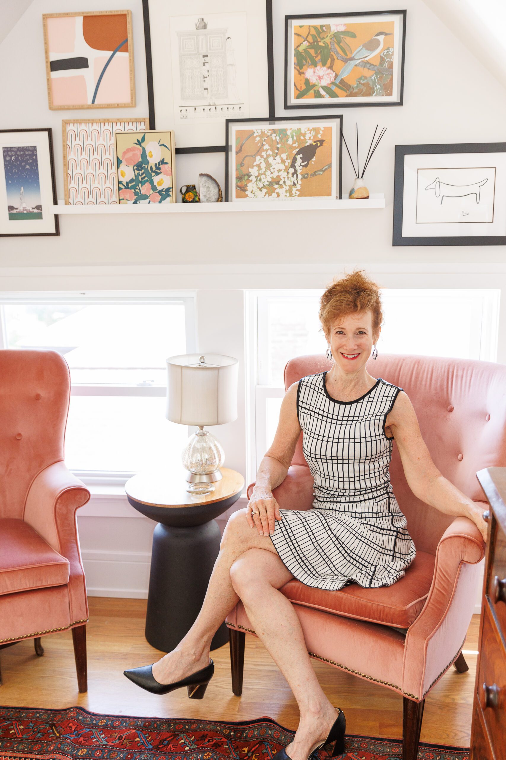 Realtor sitting in a chair of her recently rehabbed home.